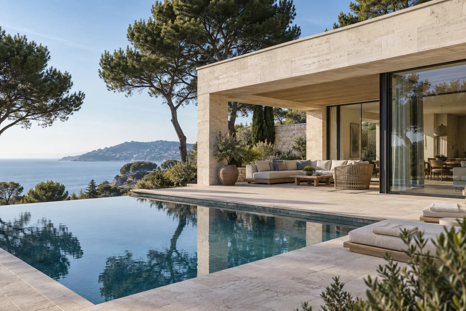 A contemporary Riviera home with a furnished terrace and a pool overlooking the sea.